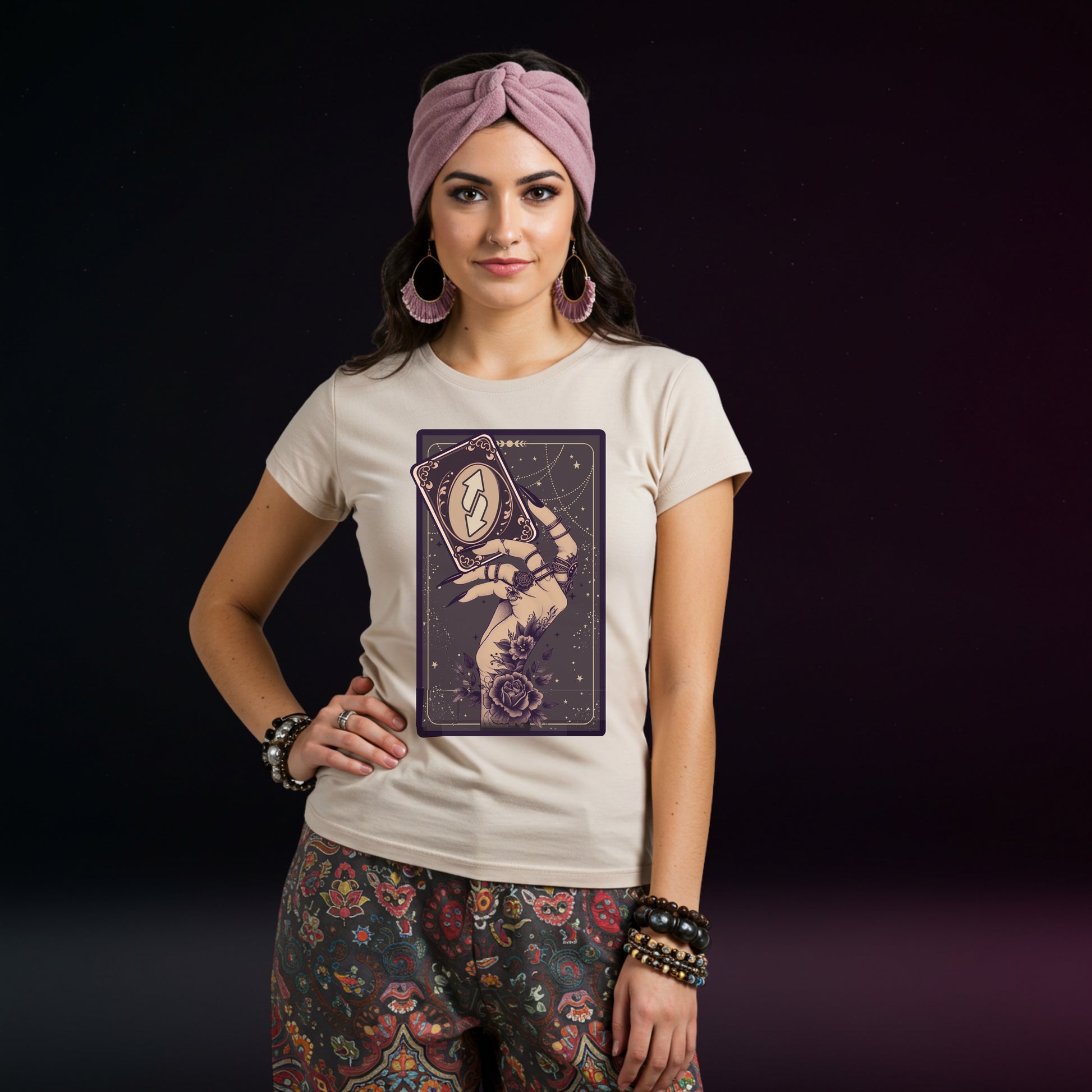 Woman wearing a vintage white t-shirt with a tarot card design on a dark background