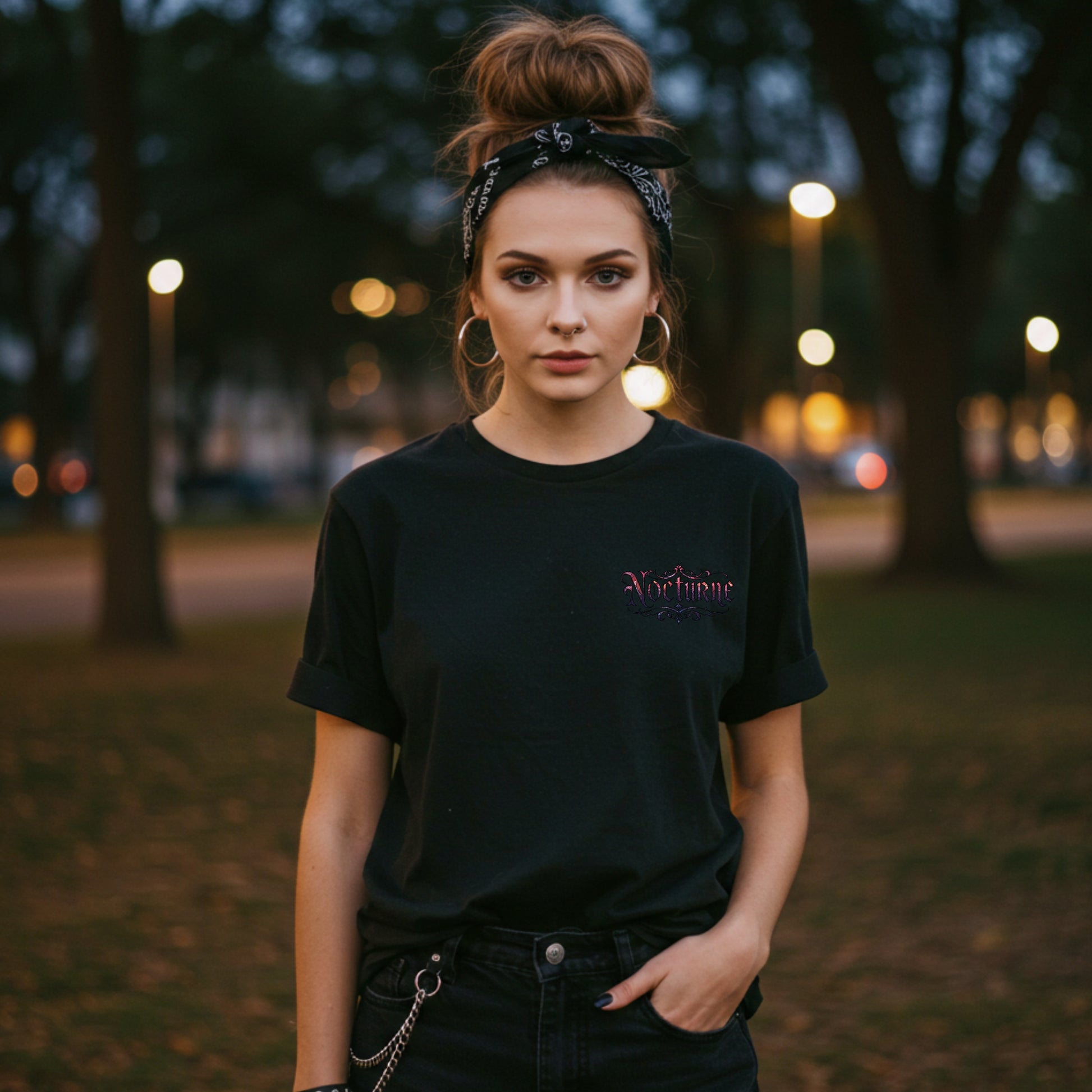 Woman wearing a black t-shirt with a logo in an outdoor setting