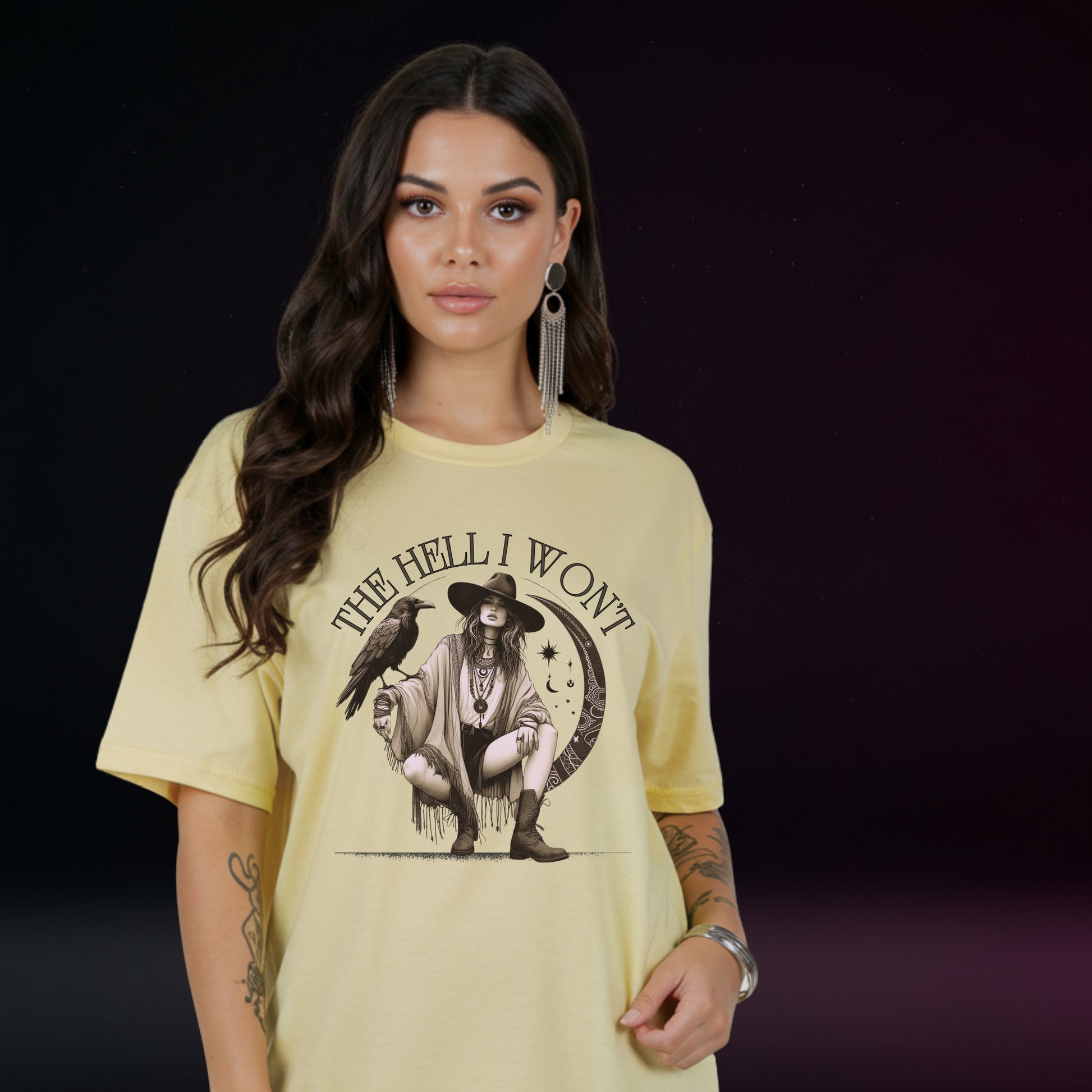 Woman wearing a yellow t-shirt with a graphic design and text on a dark background