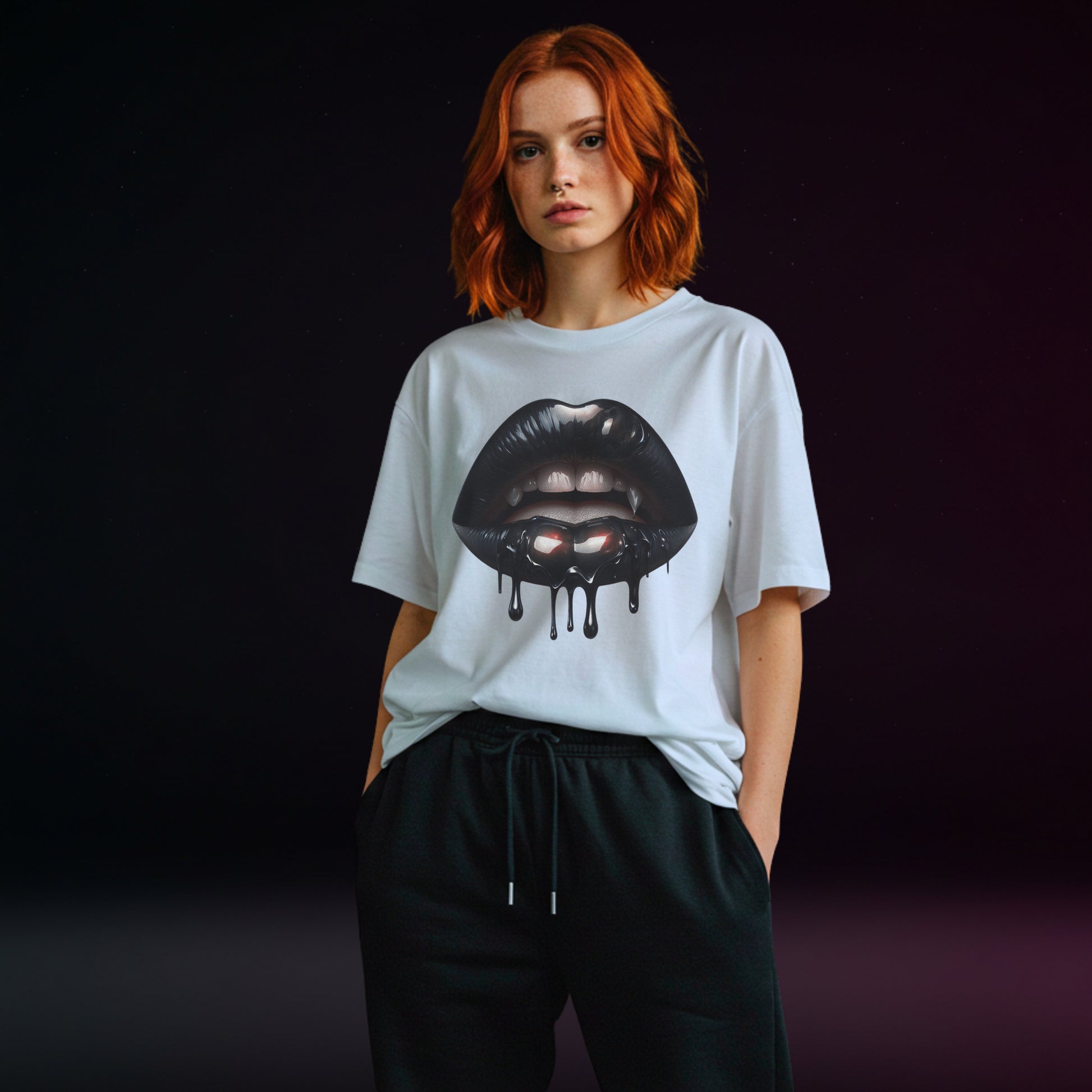 Person wearing a white t-shirt with a graphic design of black vampire lips on a dark background