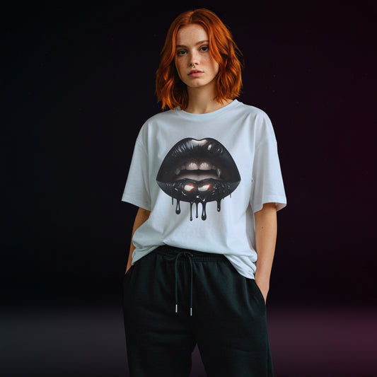 Person wearing a white t-shirt with a graphic design of black vampire lips on a dark background