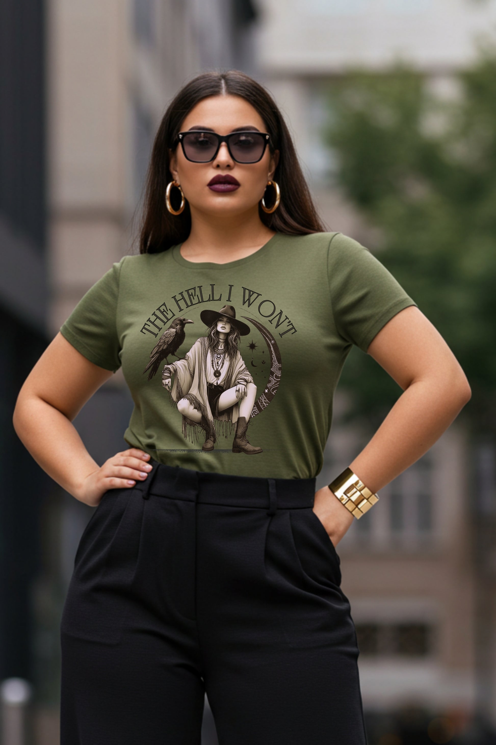 Woman wearing a green t-shirt with graphic design and text, standing outdoors.