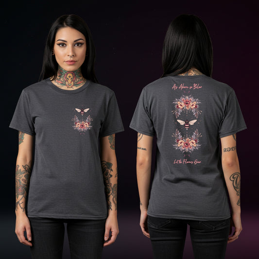 Person wearing a dark gray t-shirt with floral designs on the front and back against a black background