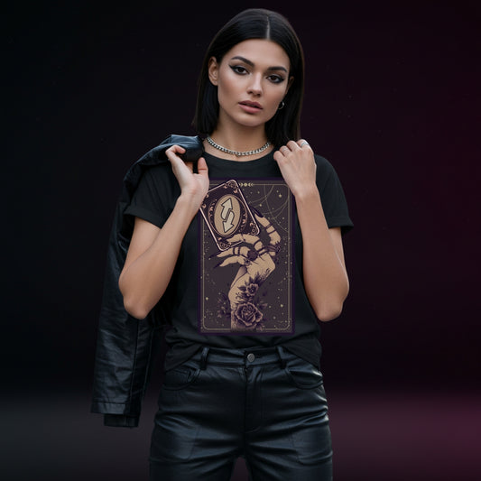 Woman wearing a black t-shirt with a tarot card design against a dark background