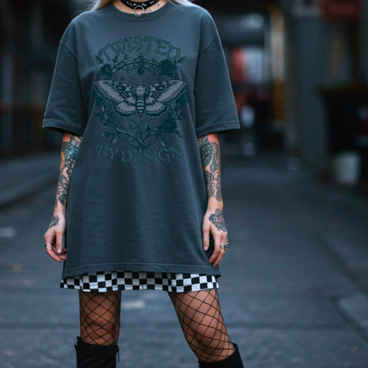 Person wearing a dark green oversized t-shirt with text and graphics, standing in an urban alleyway.