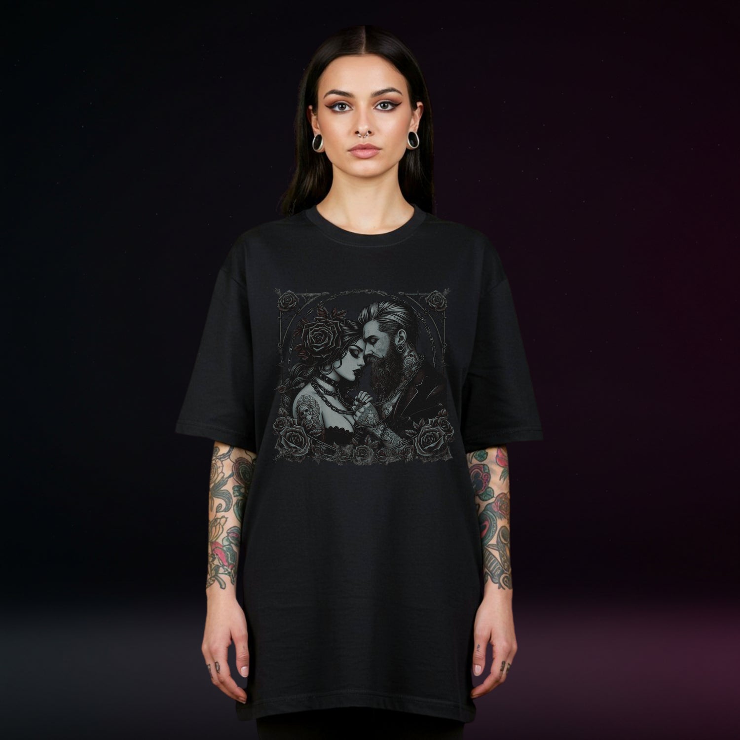 Person wearing a black t-shirt with a graphic design on a dark background