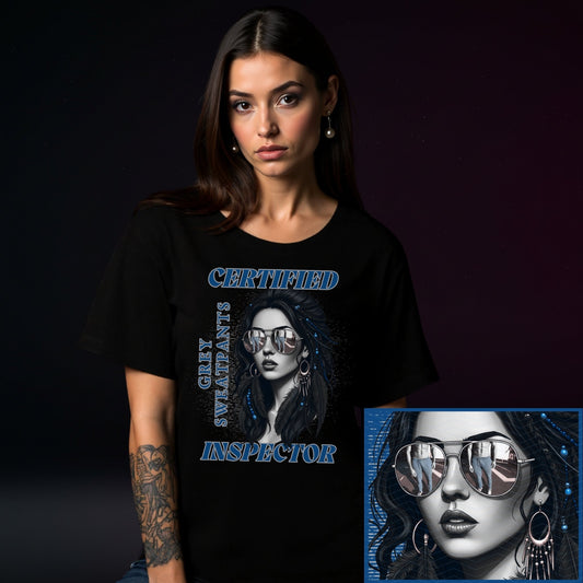 Woman wearing a black t-shirt with a graphic design of a woman wearing sunglasses and text, on a dark background.