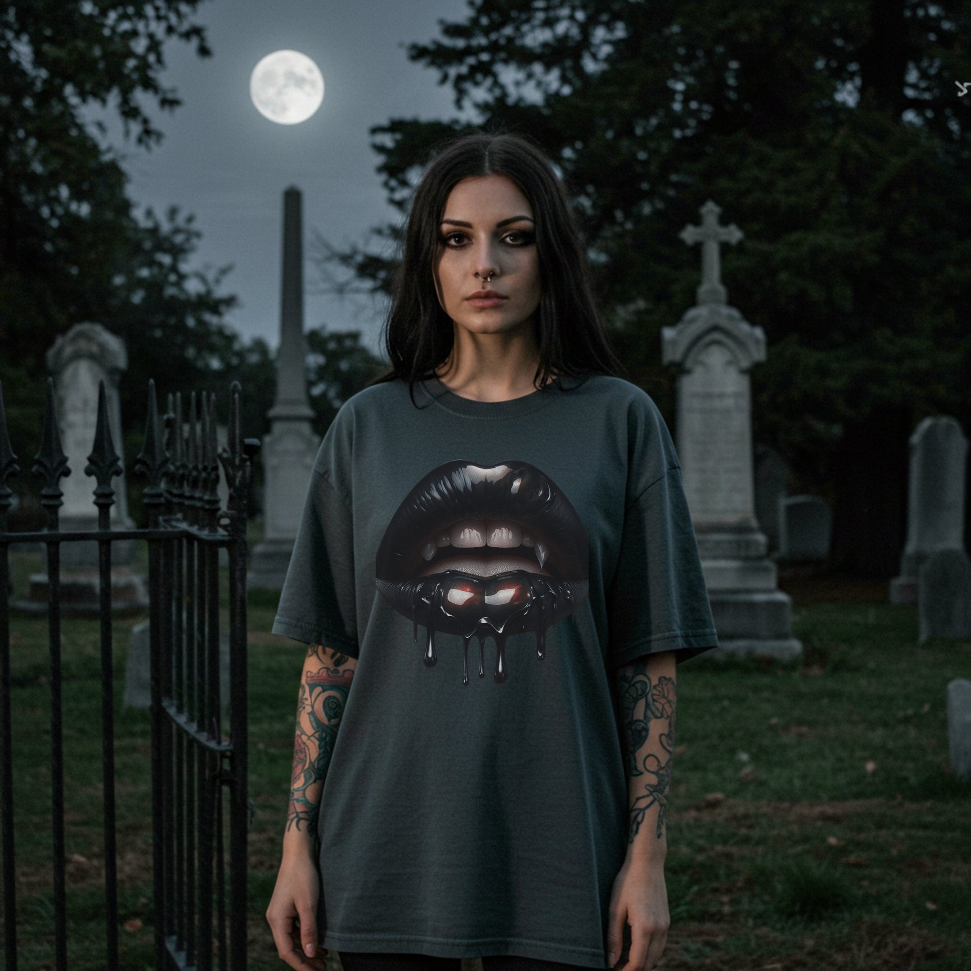 Person wearing a t-shirt with a graphic design in a cemetery under a full moon.