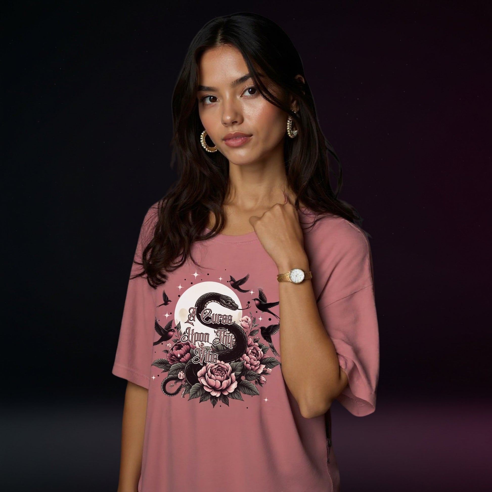 Woman wearing a pink t-shirt with a floral design on a dark background