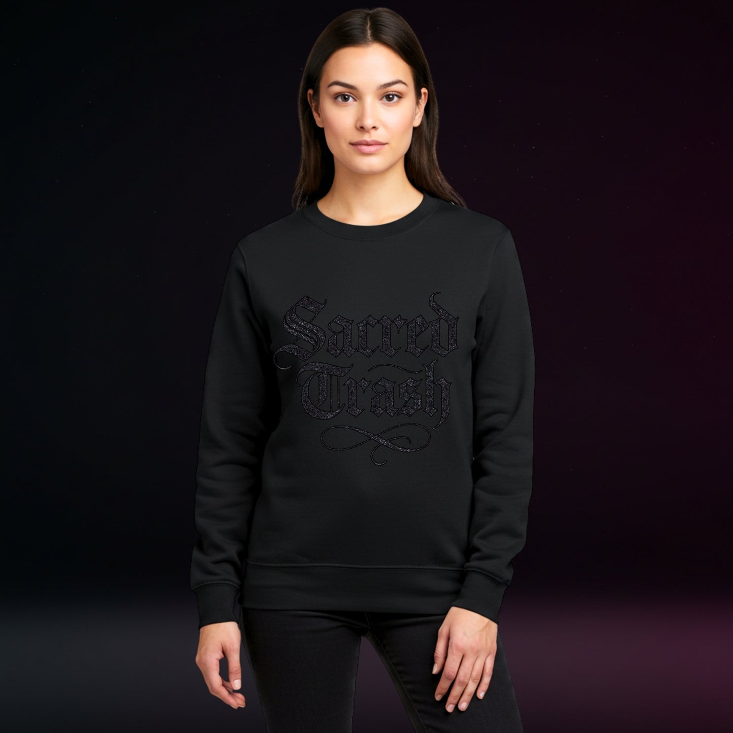 Person wearing a black sweatshirt with text on a dark background