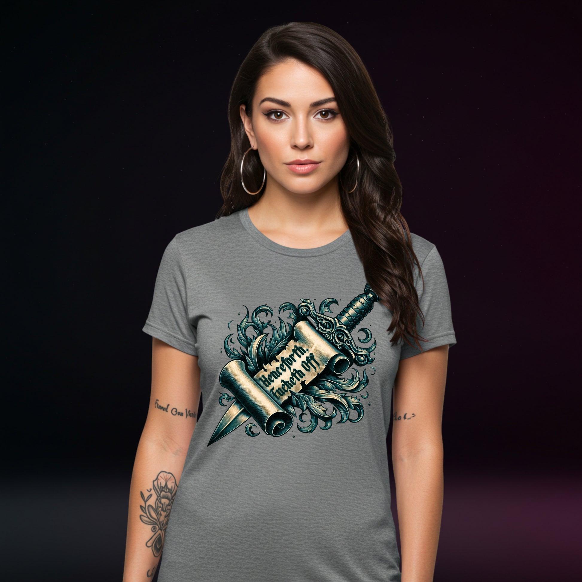 Woman wearing a gray t-shirt with a graphic design on a dark background