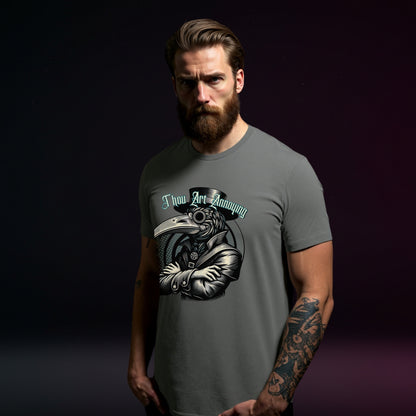 Man wearing a gray t-shirt with a graphic design on a dark background
